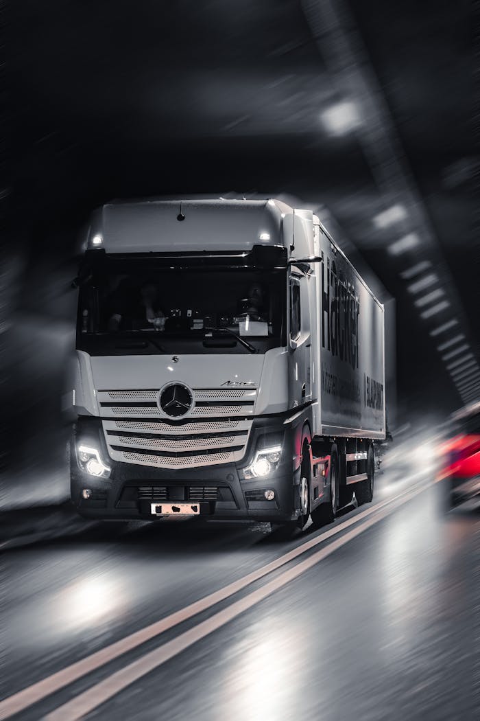 about-01 Mercedes-Benz Actros truck speeding through a city tunnel, capturing urban motion and energy.