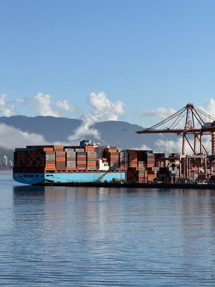 A cargo ship docked at a shipping container terminal in Vancouver, Canada.